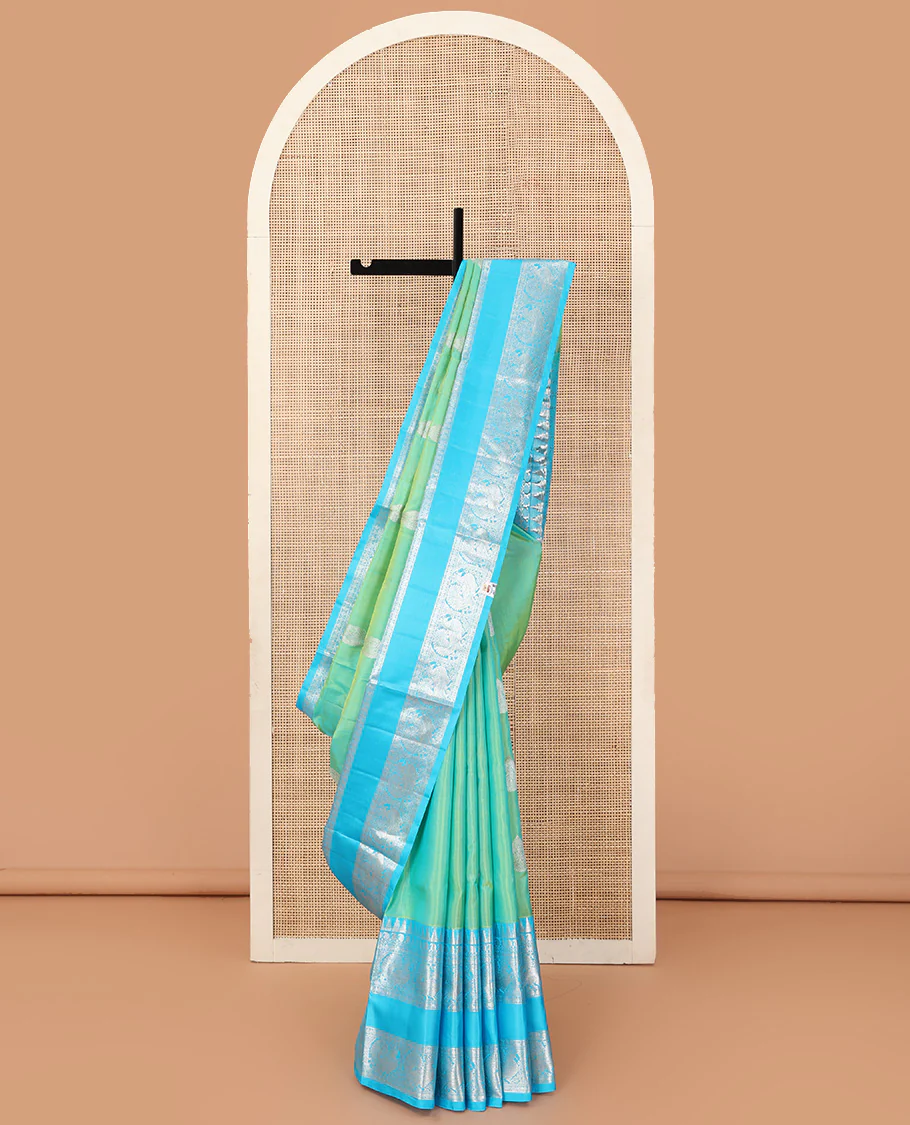 Aqua green dual-tone zari buttas Venkatagiri silk saree, contrast traditional zari rettai pettu border of peacock designs, and pallu of chakra, and rudraksham
