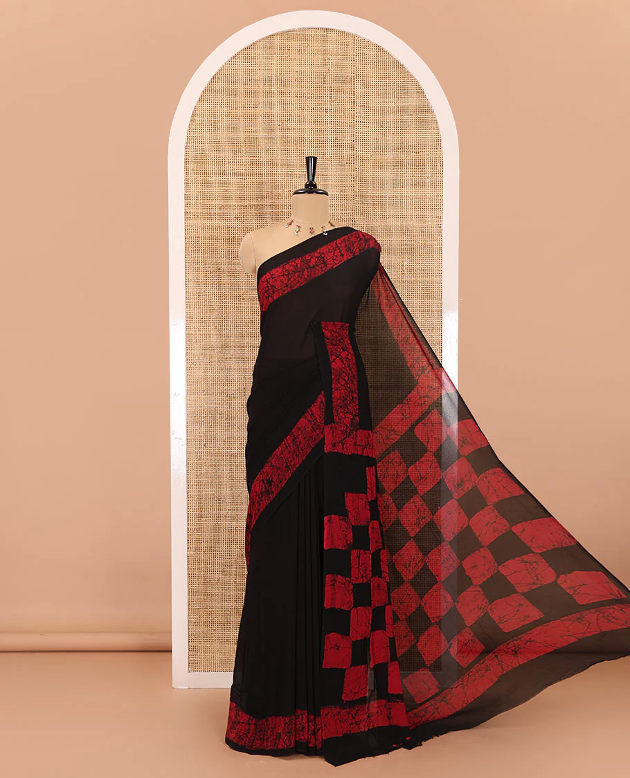 Black and rani pink plain georgette saree, batik printed border, batik printed checked pallu, and a matching blouse