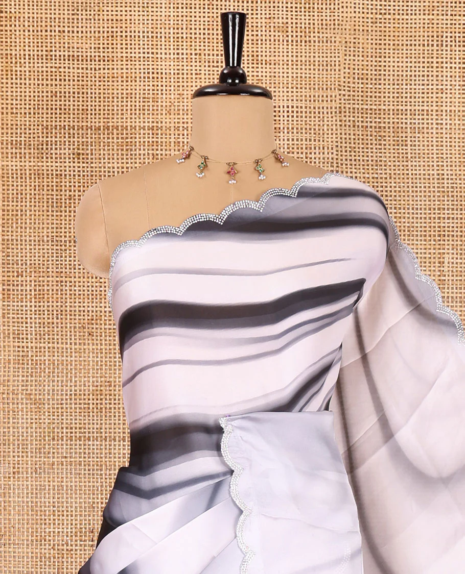 Black and white abstract printed satin crepe saree, scallop jarkan stone work border, self-pallu, and a contrast abstract printed blouse - Image 2