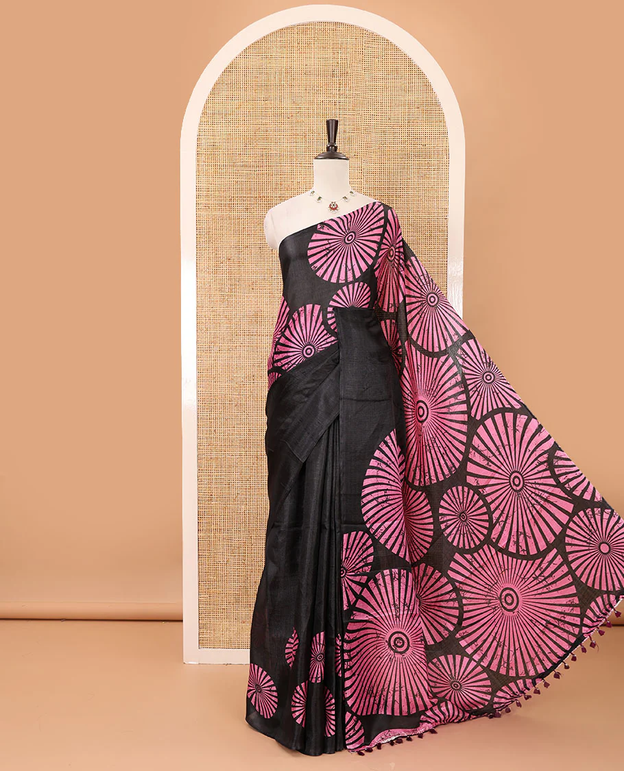 Black-base plain body khadi cotton saree with batik-style pink-color radiant sunburst design on its border & pallu, plain black blouse