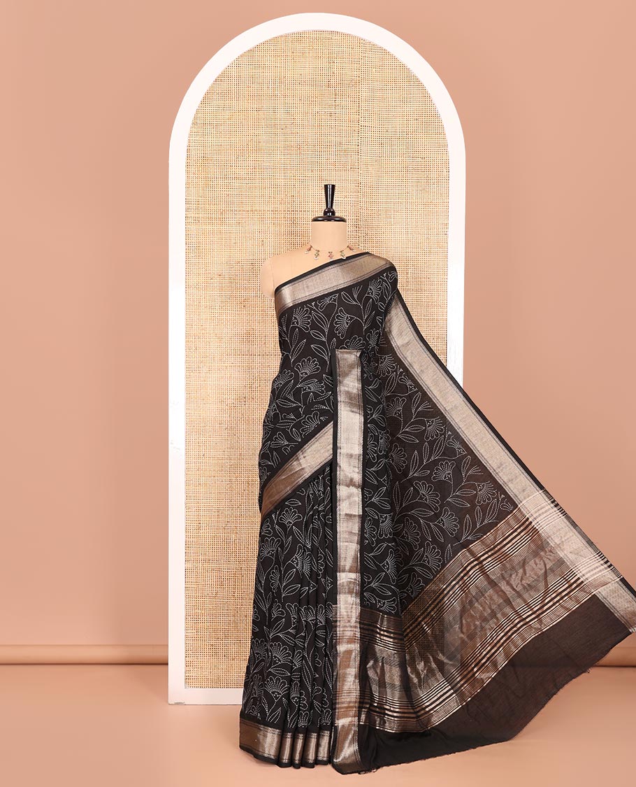 Black dotted floral discharge printed assam silk saree, chevron striped border, zari striped pallu, and a matching blouse