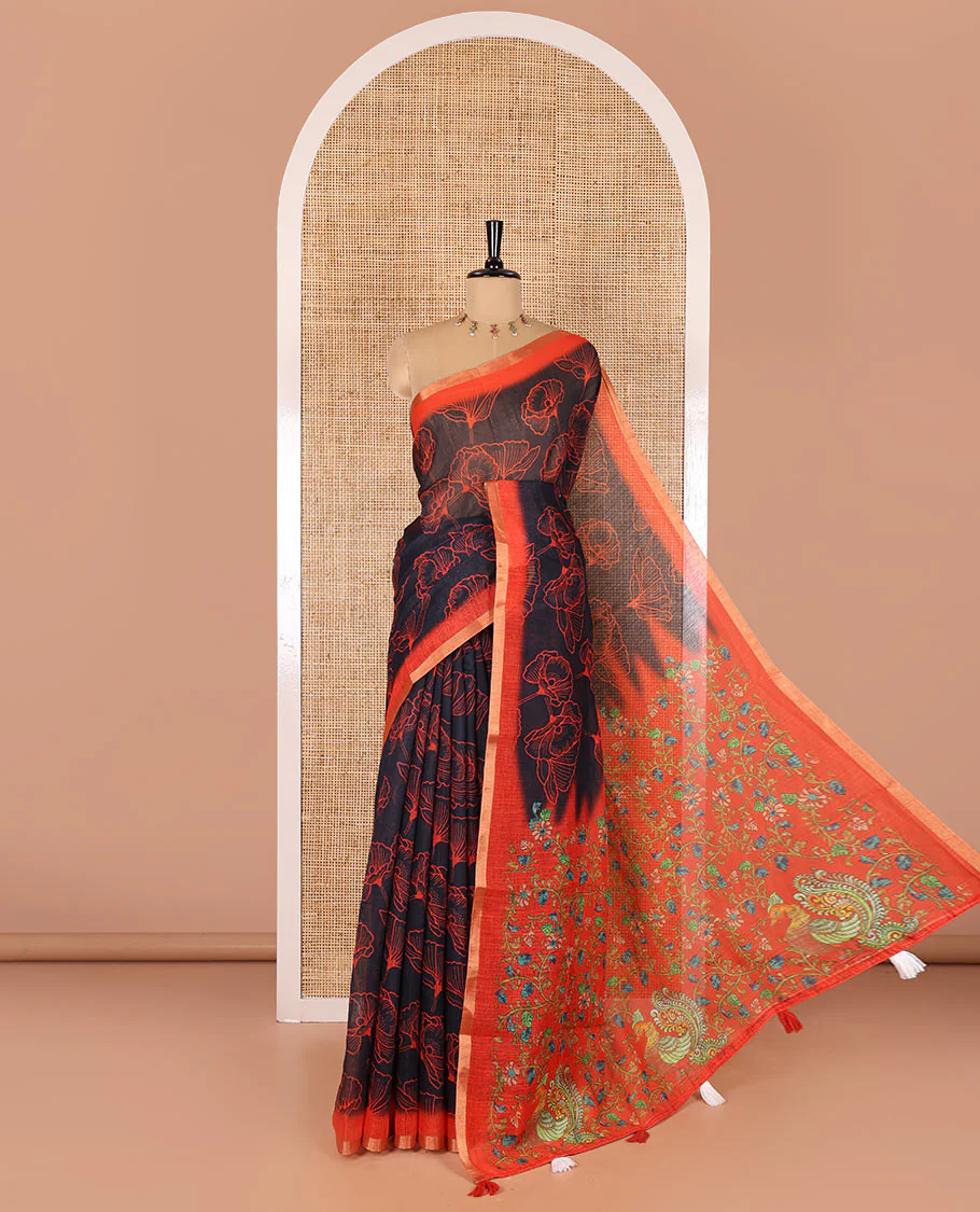 Black floral printed linen cotton saree, contrast piping border, kalamkari floral and peacock printed pallu, and a contrast floral vine printed blouse