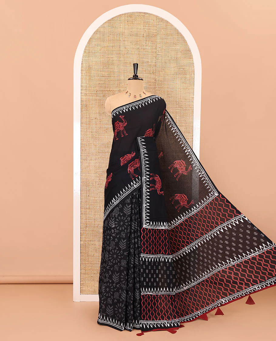 Black half-and-half style block printed soft mul cotton saree of camel and warli village print, temple border, geometric pallu, and a plain blouse