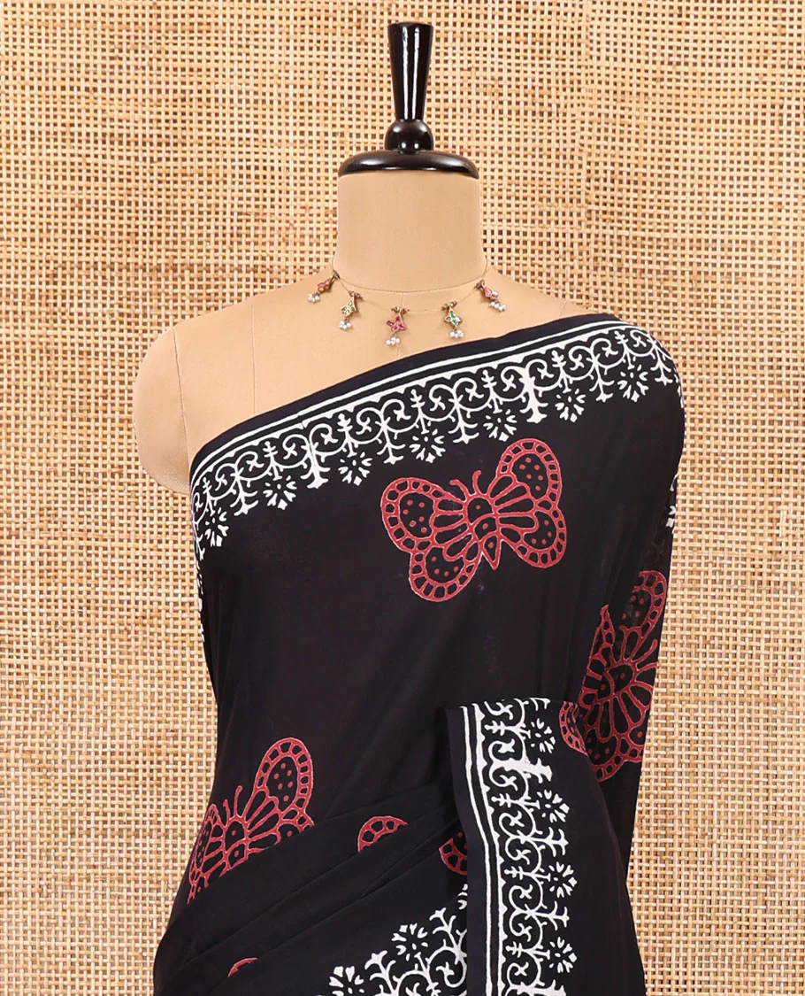 Black half-and-half style butterflies and warli theme block printed soft mul cotton saree, printed border, floral printed pallu, and a plain blouse - Image 3
