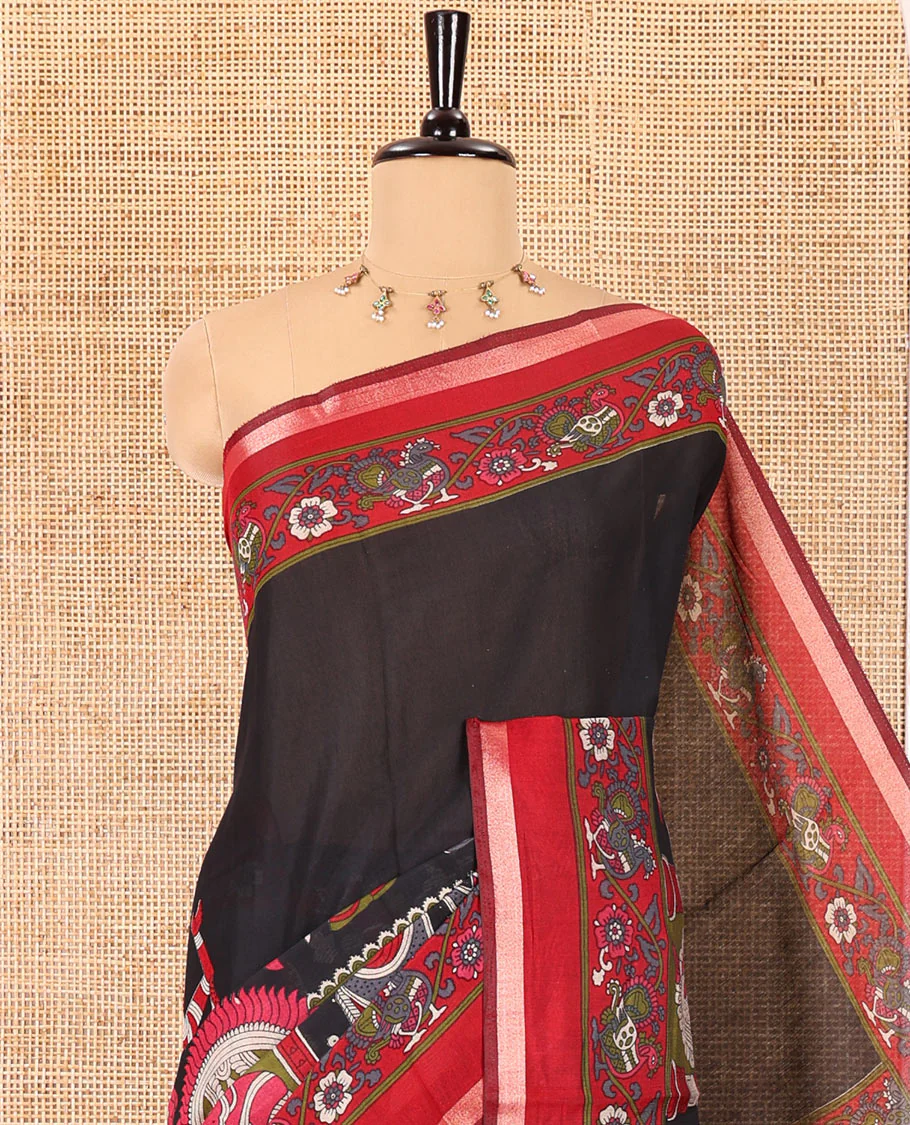 Black human figurines printed muslin cotton saree, contrast floral-peacock printed border of piping work, kalamkari printed pallu, and a contrast blouse of flower motifs print - Image 2