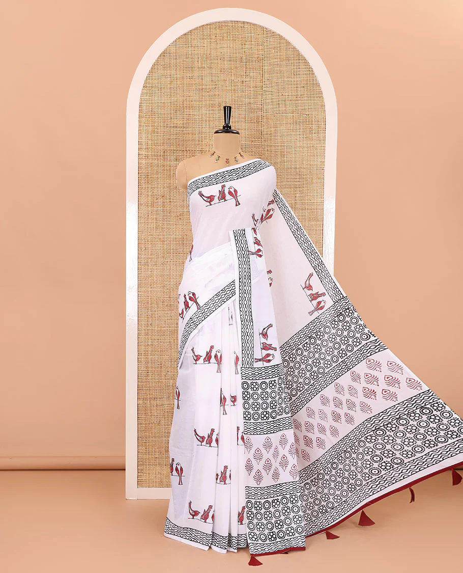 White sparrow motifs hand block printed soft mul cotton, block printed geometric border, intricate motifs printed pallu, and a contrast plain blouse