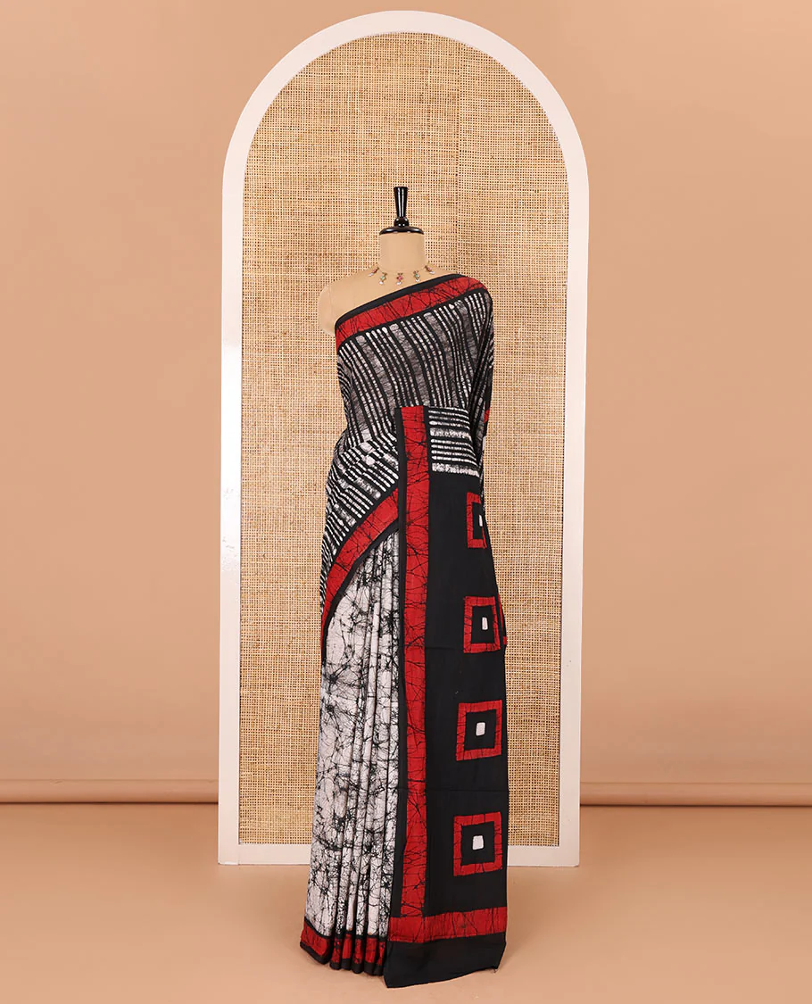 Black vertical stripes printed mul cotton saree, contrast batik printed border, pallu of geometric batik print, and a contrast printed blouse - Image 2