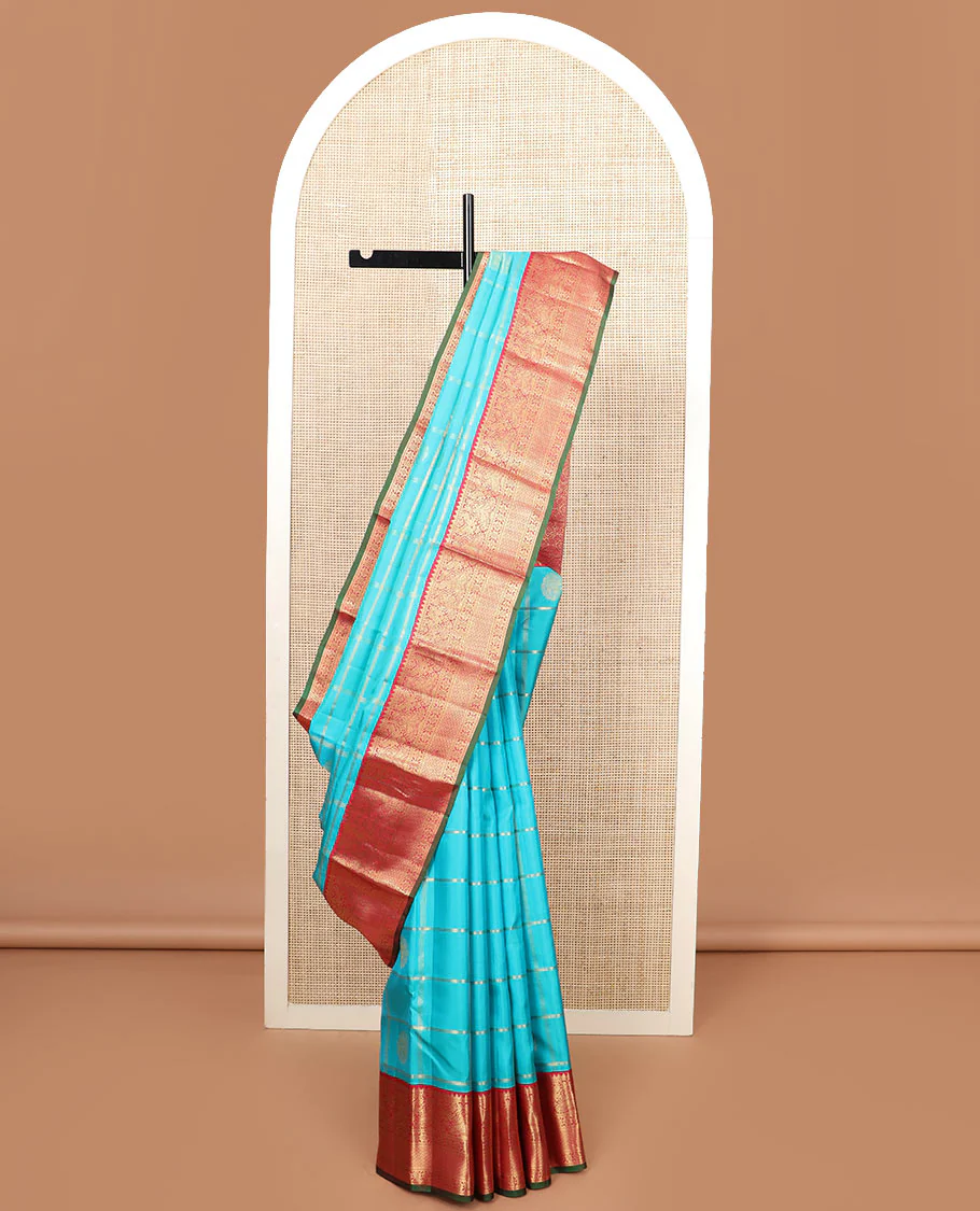 Blue butta enclosed checked Vasundhara silk saree, contrast border of rekku, muthu, manga, mayil, and kamalam designs, and jaal pallu