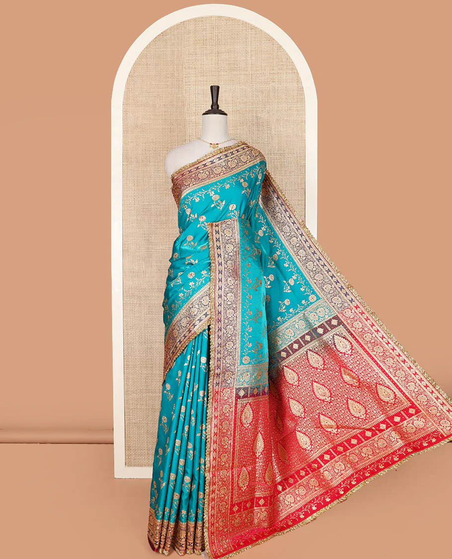 Blue floral buttas with stone work banarasi silk saree, contrast lace zari border of floral creeper designs, and pallu of Mughal-style intricate motifs