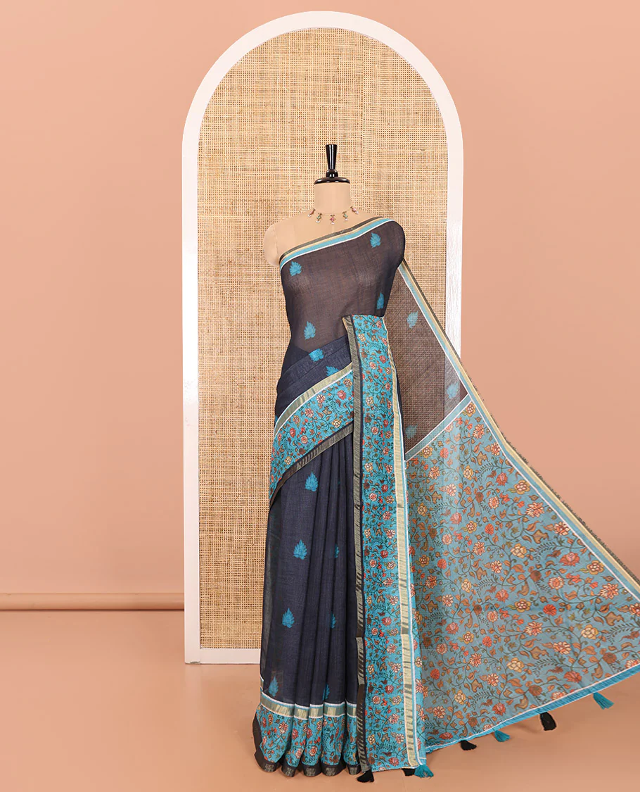 Blue Linen Saree Accentuated with Leaf Motifs All Over Its Body, Complemented by a Contrast Floral Vine Printed Border, Pallu Mirrors the Floral Vine Print, and Paired with a Contrast Floral Printed Blouse