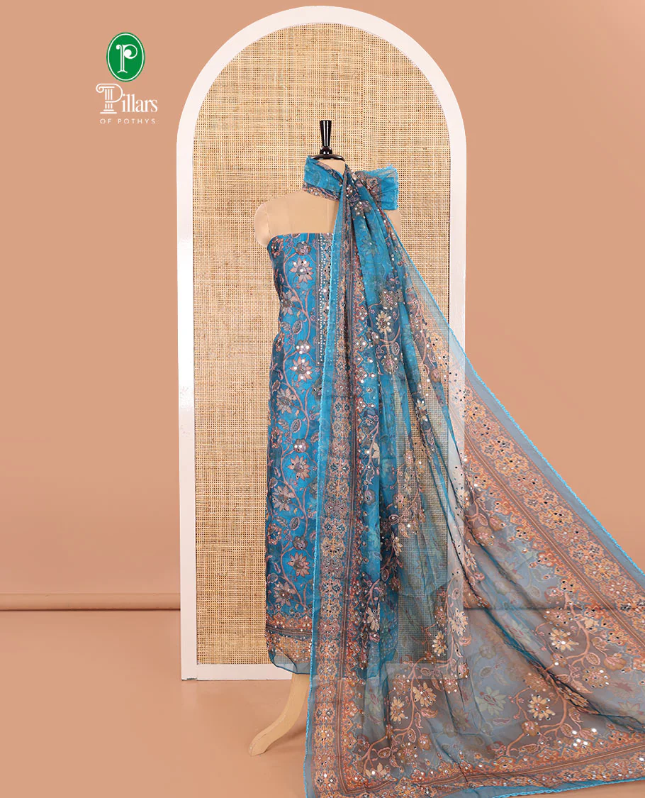 Blue Material Chudidar Set Embellished with Floral Vine with Mirror Work Organza Top, Subtly Made Plain Santoon Bottom, and Organza Dupatta Featuring Floral Vine Print and Mirror Work