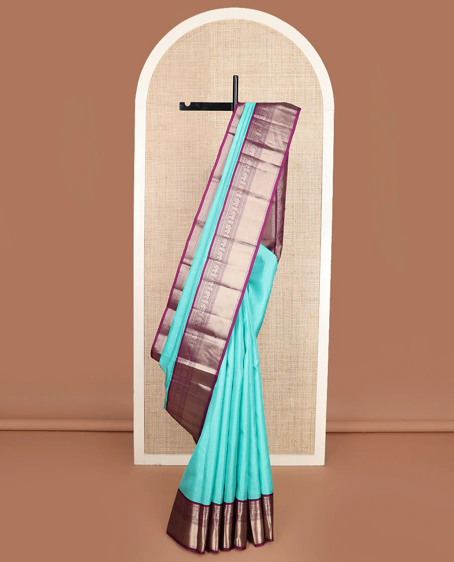 Blue micro-checked Vasundhara silk saree, contrast border of salngai, banaras, laddu kamalam, and annam motifs, and jaal design pallu