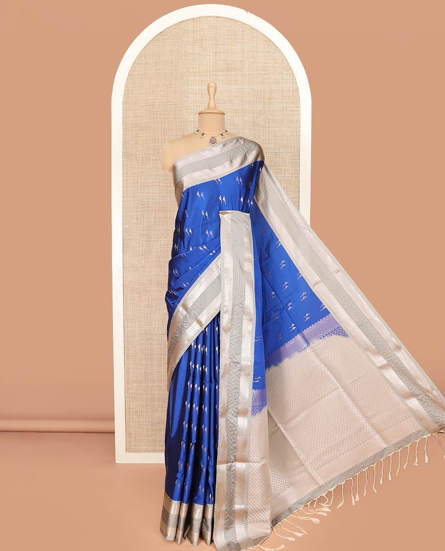 Blue Semi-Soft Silk Saree Gracefully Embellished with Zari Buttas, Complemented by Contrast Traditional Zari Border, Zari Elevated with Pallu of Jaal Designs, and Paired with a Contrast Blouse