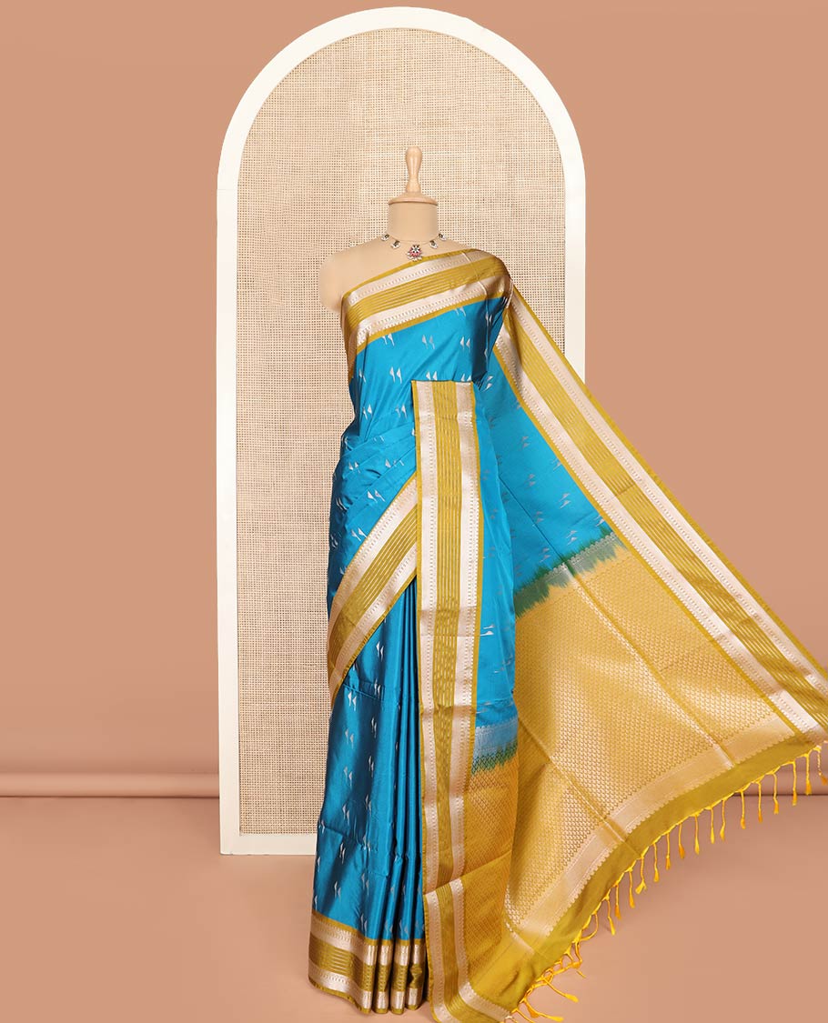 Blue Semi-Soft Silk Saree Highlighted with Zari Buttas, Complemented by Contrast Traditional Zari Design Vasrisai Pettu Border, Pallu Intricately Designed with Jaal Designs, and Paired with a Contrast Blouse