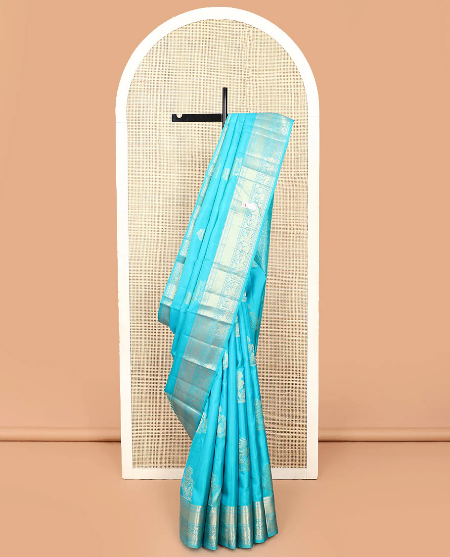 Blue singam and yaanai buttas Vasundhara silk saree, zari border of yaanai, mayil kann, muthu, mayil kann, rudraksham, mayil, and yaali designs, and butta enclosed checked pallu