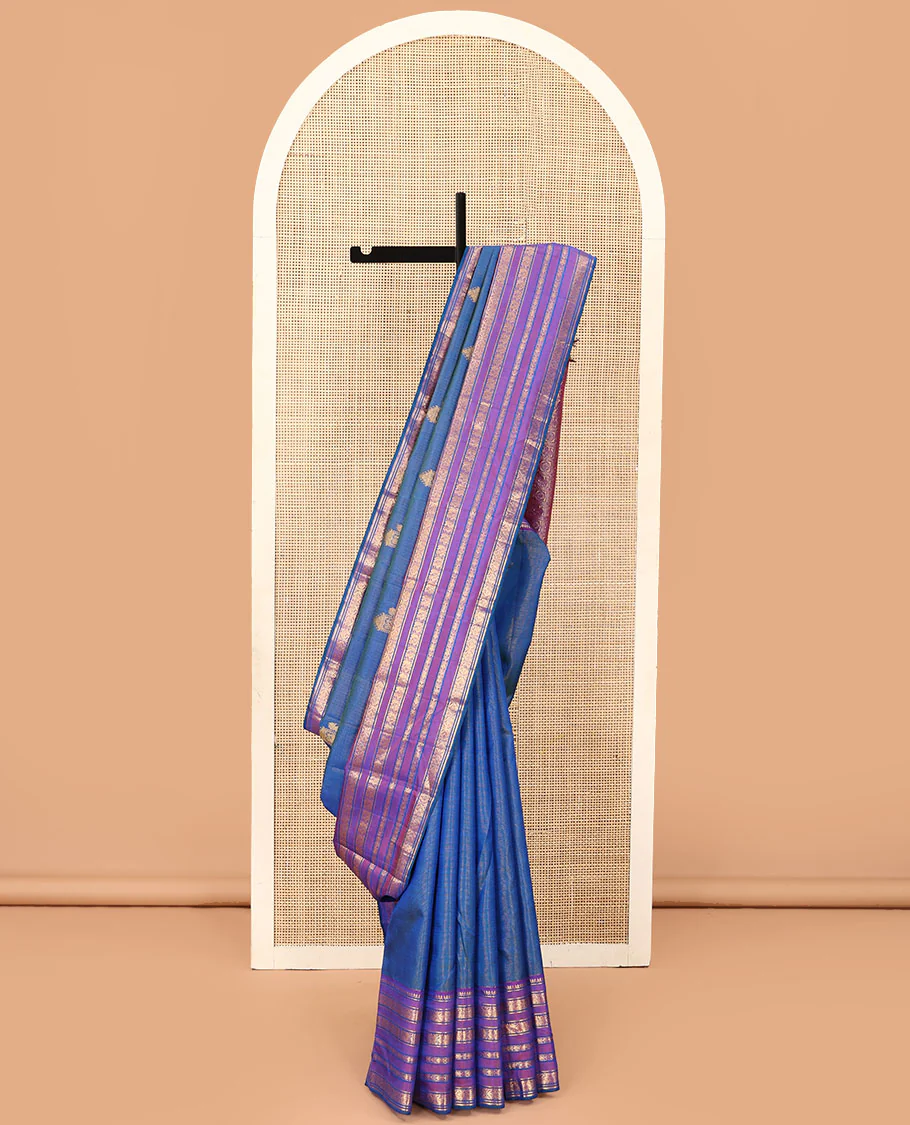 Blue striped and mayil buttas Kanchipuram silk saree, contrast border of thilakam mokku, mayil, and meen designs and annam chakram butta enclosed checked pallu