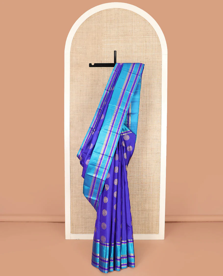 Blue Vasundhara Silk Saree Majestically Detailed with Round Mayil Buttas, Complemented with a Contrast Border of Traditional Zari Designs, Richly Detailed Pallu of Jaal Designs, and Paired with a Contrast Blouse