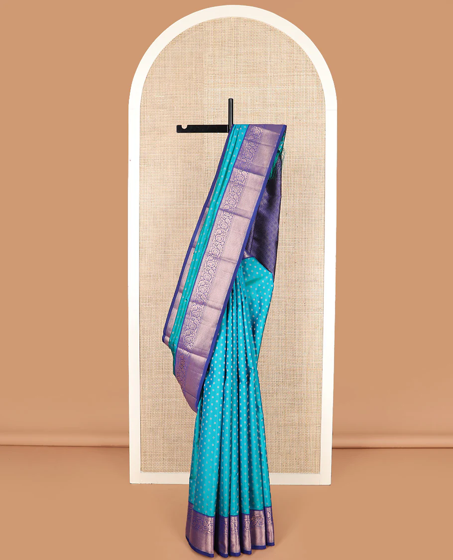 Blue zari buttas Vasundhara silk saree, contrast border of rekku, kodi visiry, and jaal designs, and zari-rich jaal pallu