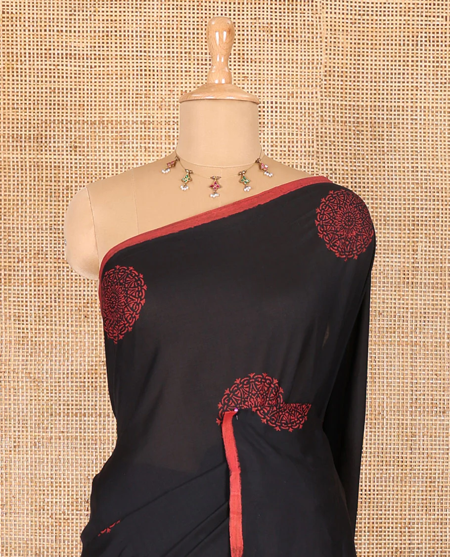 Borderless black rangoli-style chakram motifs printed South cotton saree with a matching blouse, and a contrast floral printed blouse - Image 3