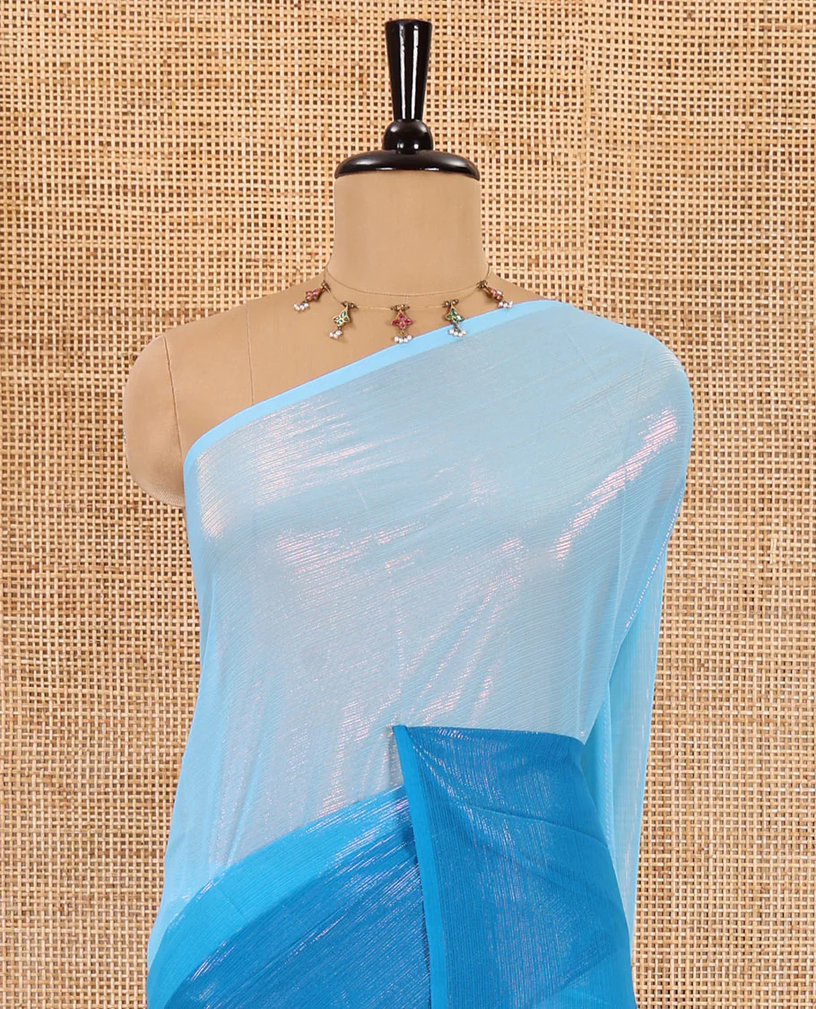 Borderless blue ombre-toned gleaming Shimmer Georgette saree, self-pallu with tassels and a plain blue blouse - Image 3