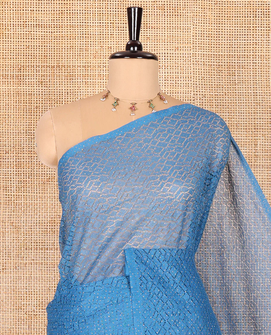 Borderless blue sparkling glitter russel net saree with self-pallu, and a contrast floral printed and zig-zag patterned blouse - Image 2