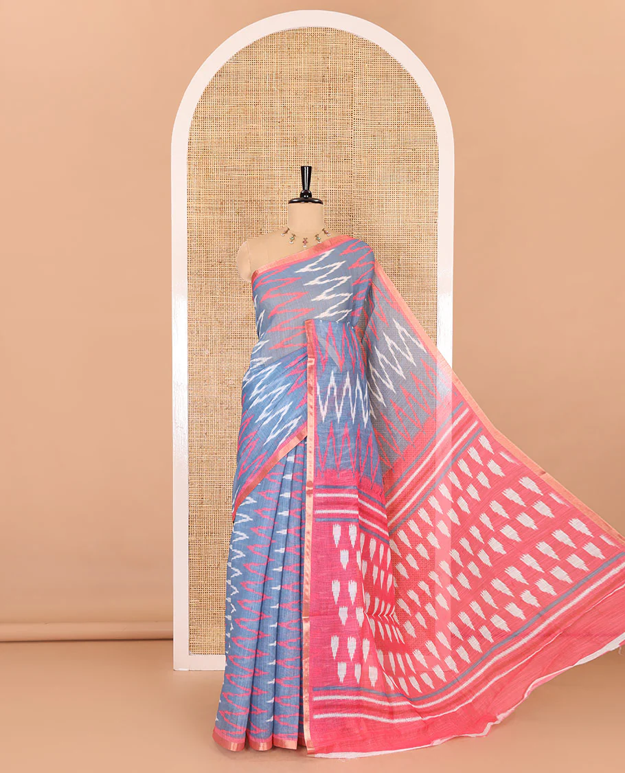 Borderless grey ikkat chevron patterned linen cotton saree, contrast zari piping border, ikkat buttas pallu, and a contrast ikkat buttas blouse