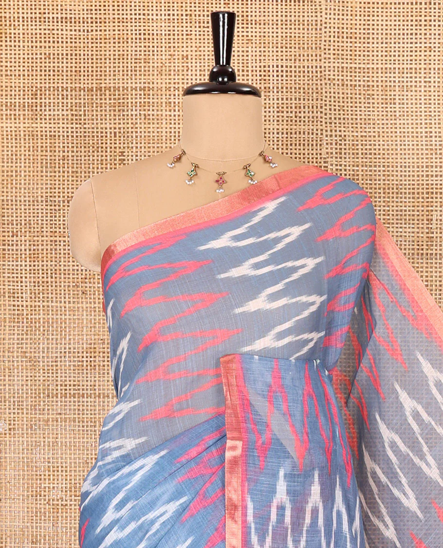 Borderless grey ikkat chevron patterned linen cotton saree, contrast zari piping border, ikkat buttas pallu, and a contrast ikkat buttas blouse - Image 2