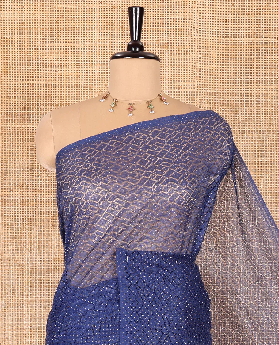 Borderless navy blue sparkling glitter russel net saree with self-pallu, and a contrast floral printed and zig-zag patterned blouse - Image 2