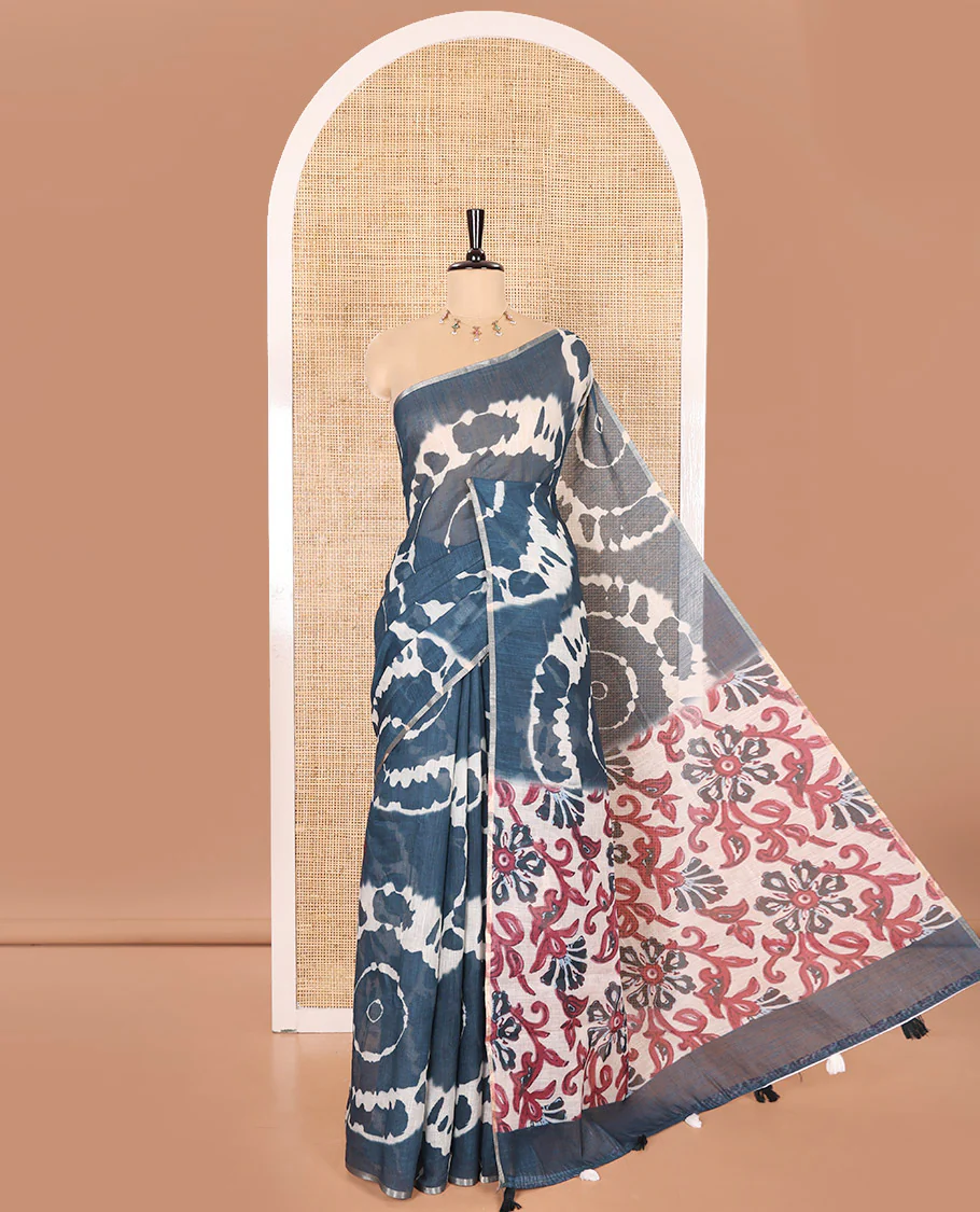 Borderless Petrol Blue Linen Cotton Saree Elevated with Shibori Prints, Complemented by Contrast Pallu Steeped with Floral Vine Print, and Paired with a Contrast Floral Printed Blouse