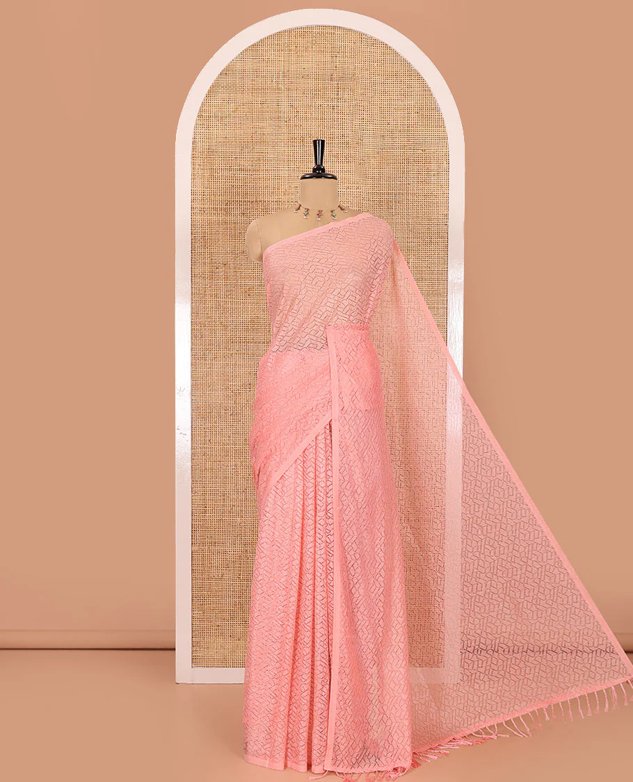 Borderless pink sparkling glittered russel net saree, self-pallu and a floral print with zig-zag embroidered blouse