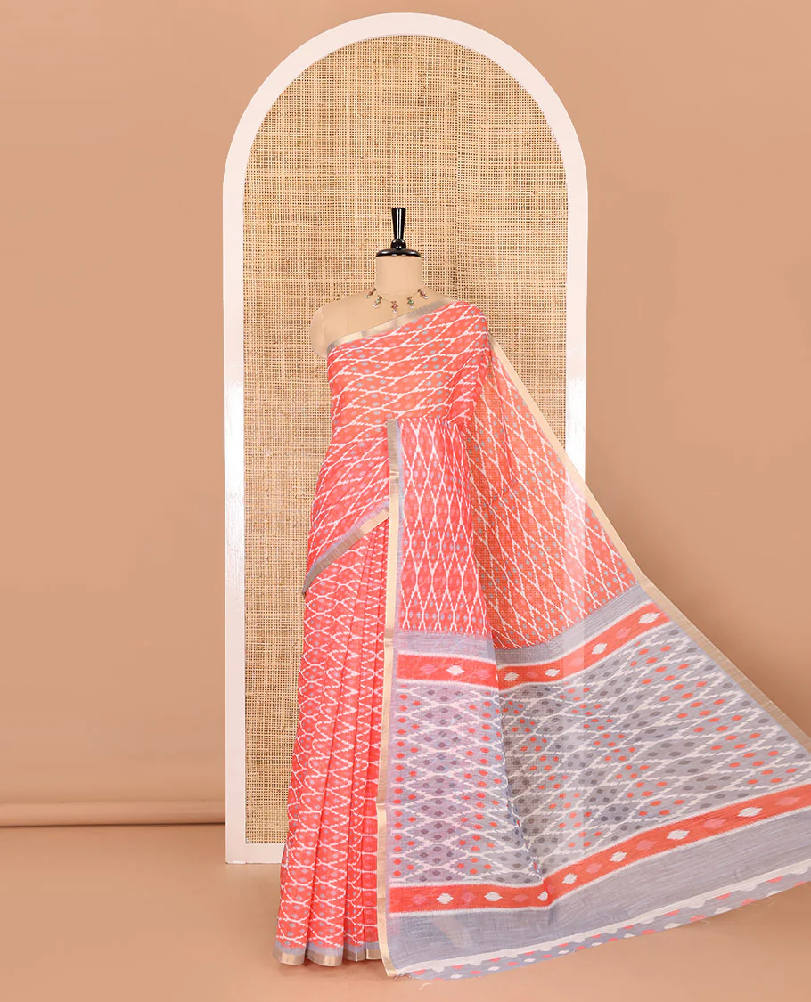 Borderless tomato pink ikkat jaal patterned linen cotton saree, contrast ikkat jaal patterned pallu and ikkat buttas blouse
