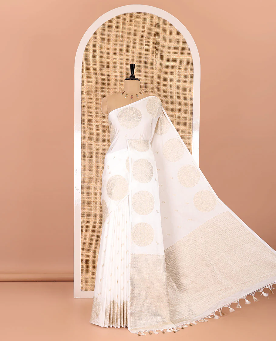 Borderless white zari buttas and chakram buttas mushru silk saree, ogee patterned pallu, and a matching blouse
