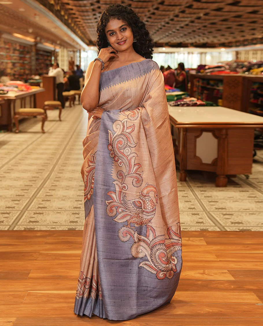 Chikku and Grey Plain Semi-Tussar Saree Accentuated with a Contrast Temple Kalamkari Floral-Printed Border, Featuring a Pallu Adorned with Kalamkari Peacock Print, Paired with a Printed Blouse