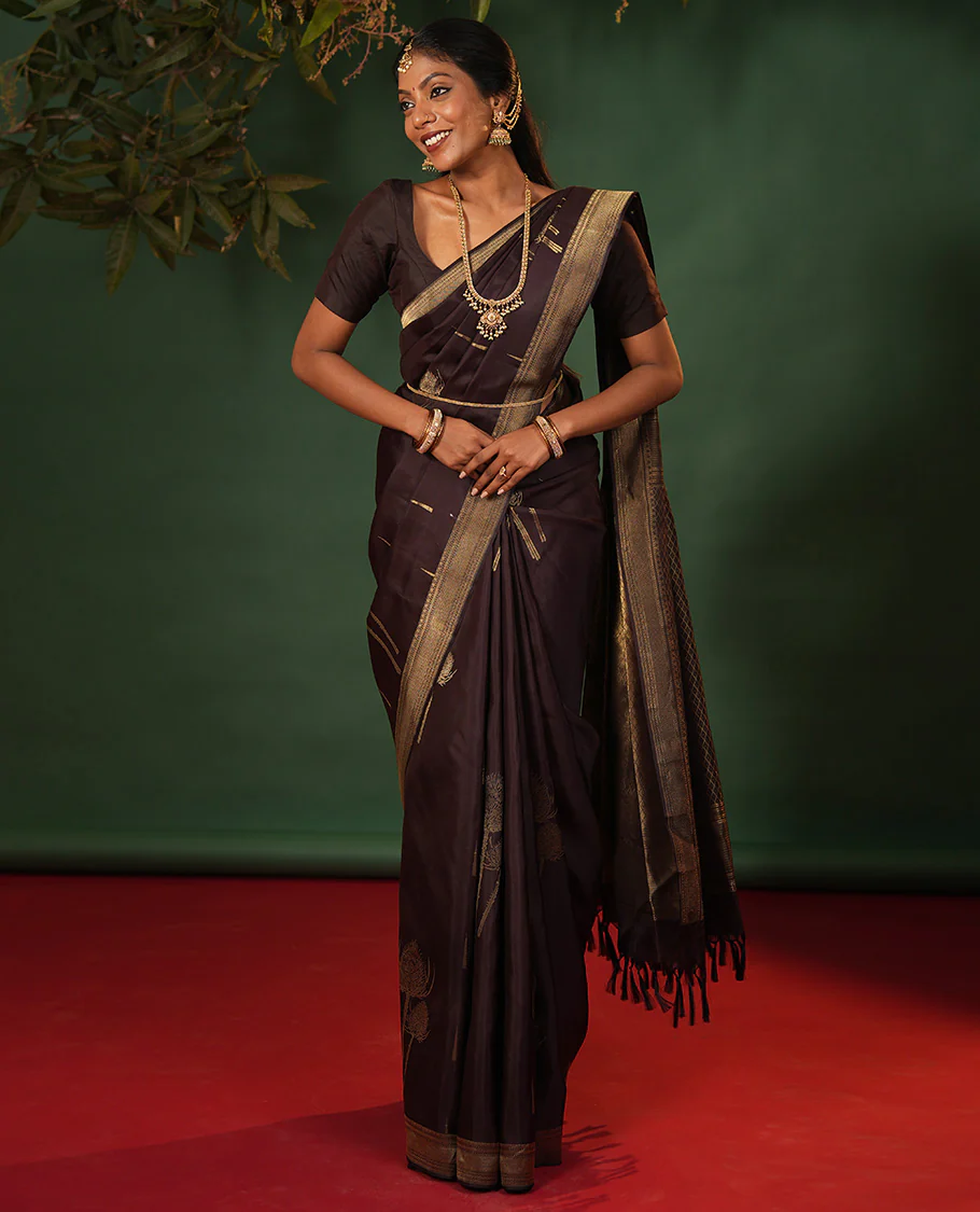Coffee brown thazampoo rekku, and vel buttas Vasundhara silk saree, zari border of manga, muthu, kathir, neli, and vanki designs, and jaal pallu