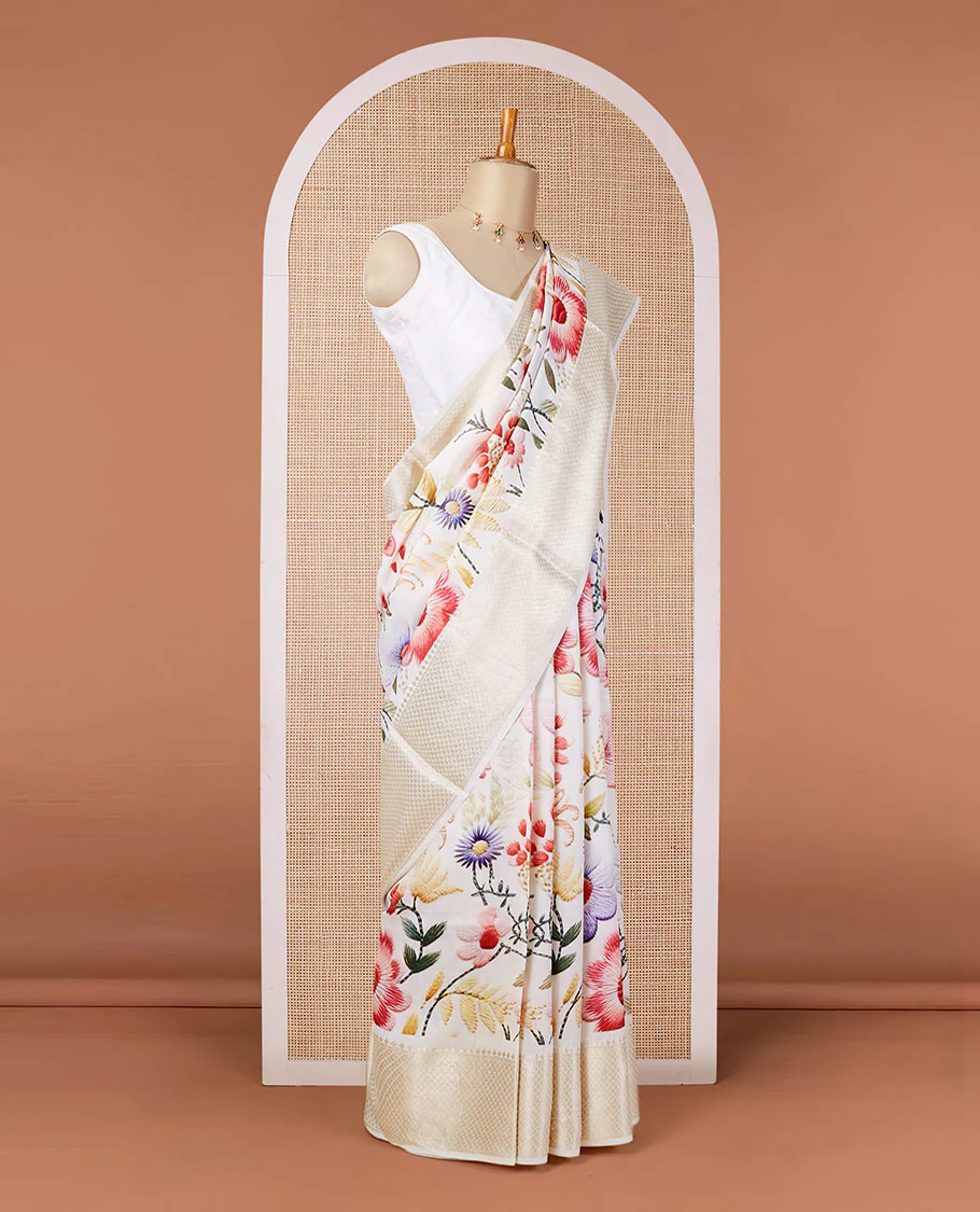 Cream digital printed chiniya silk saree with colorful floral motifs, traditional zari border & zari pallu