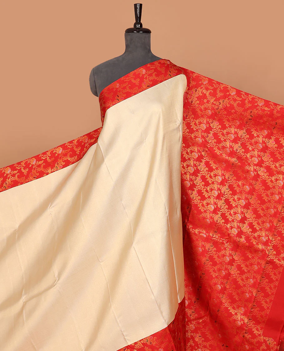 Cream embossed Samudrika silk saree, contrast red border & pallu features meenakari resham thread woven floral jaal design