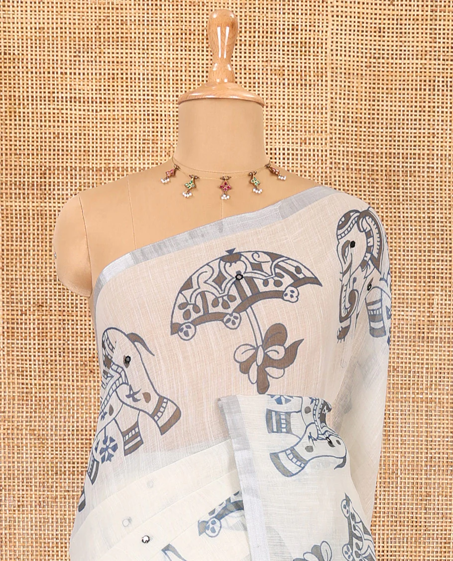 Cream mirror work linen cotton saree, zari border of umbrella and elephant motifs print, pallu of print and mirrorwork, and a contrast printed blouse - Image 3