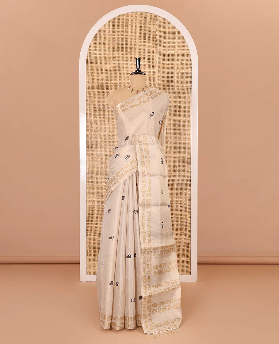 Cream-mustard Malayalam letter printed tissue saree, self-border and pallu steeped with Malayalam letter motifs, and a contrast plain blouse - Image 2
