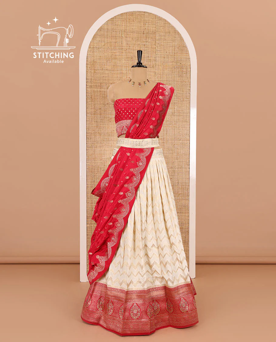 Cream-pink chiniya crepe half-saree, chevron zari jacquard with contrast intricate patterned stone work bordered skirt, contrast blouse, and a scallop bordered intricate dhavani
