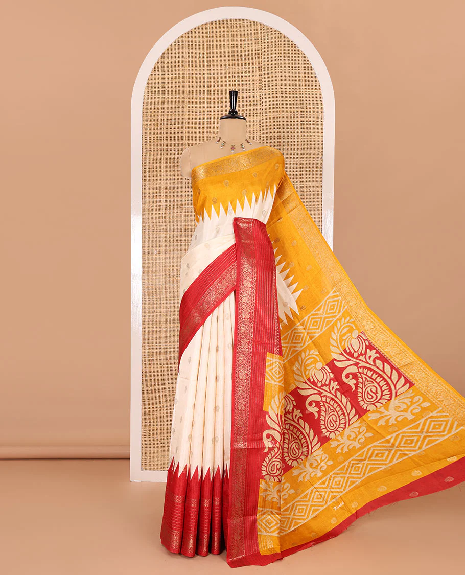 Cream zari buttas woven dola silk saree with contrast red-yellow ganga jamuna traditional zari border, paisley motifs pallu, and a contrast zari blouse