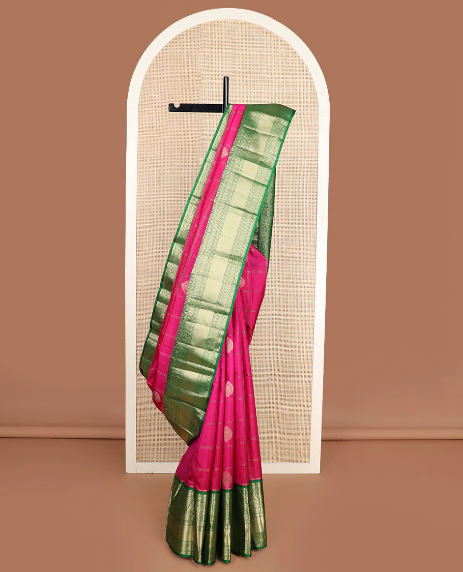 Dark pink zari buttas and checked Vasundhara silk saree, contrast border of rekku, muthu, diamond, yaanai, and chakram designs, and floral jaal pallu