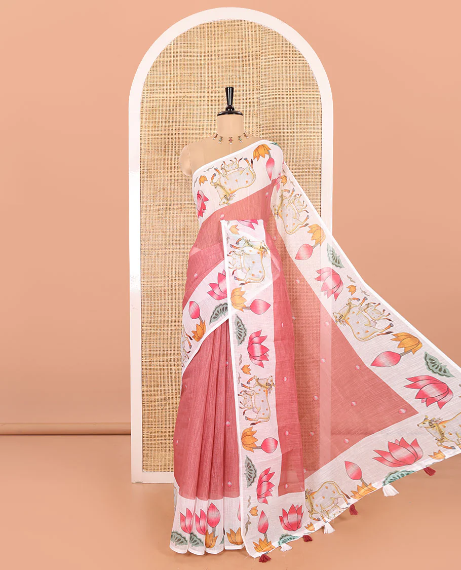 Dusky Pink Linen Cotton Saree Decked Up with Lotus Buds Buttas, Complemented by a Contrast Border of Pichwai Cow and Lotus Motif Prints, a Pallu Mirroring the Same Print, and Paired with a Lotus-Printed Blouse
