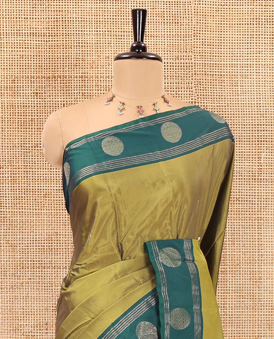 Green dobby style buttas semi-soft silk saree, contrast round buttas and striped border, striped pallu, and a plain blouse - Image 3