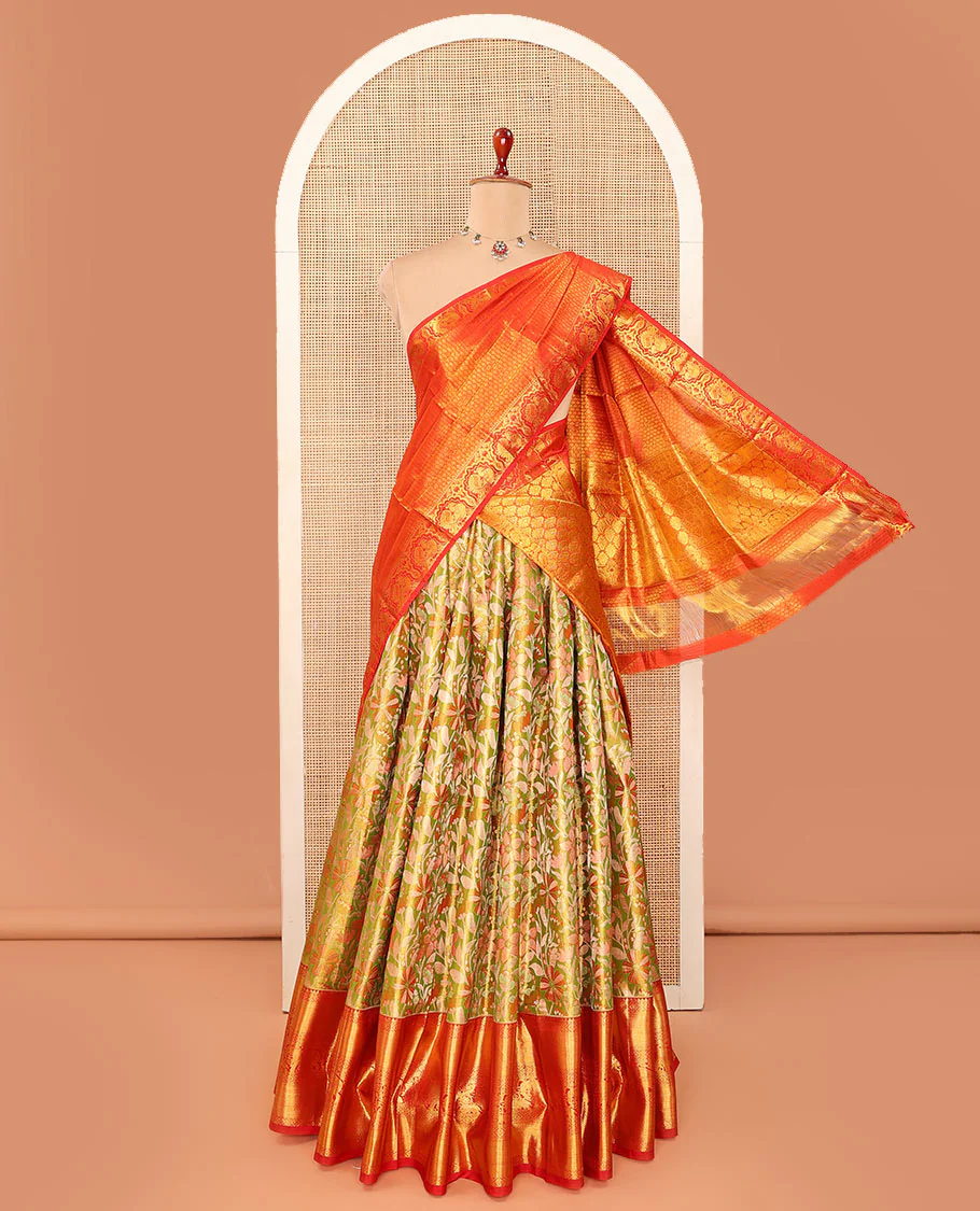 Green floral jaal jacquard pure-silk half-saree with contrast border of rekku, muthu, laddu kamalam, mayil kann, and yaanai designs, a zari bordered blouse, and a contrast intricately zari woven dhavani