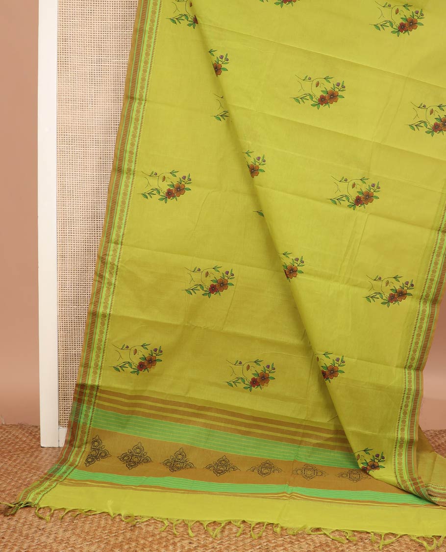 Green girl with a floral head motifs printed chirala cotton saree, traditional border, and pallu of stripes and kolam motifs print - Image 2