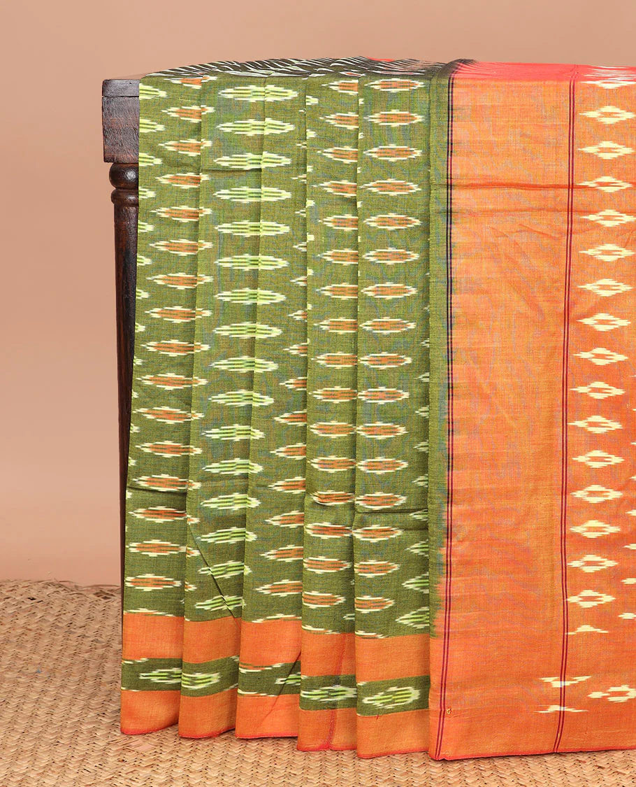 Green Ikkat Cotton Saree Adorned with Buttas in Ikkat Weave, Complemented by a Contrast Ikkat Border, and Pallu Steeped with Ikkat Buttas