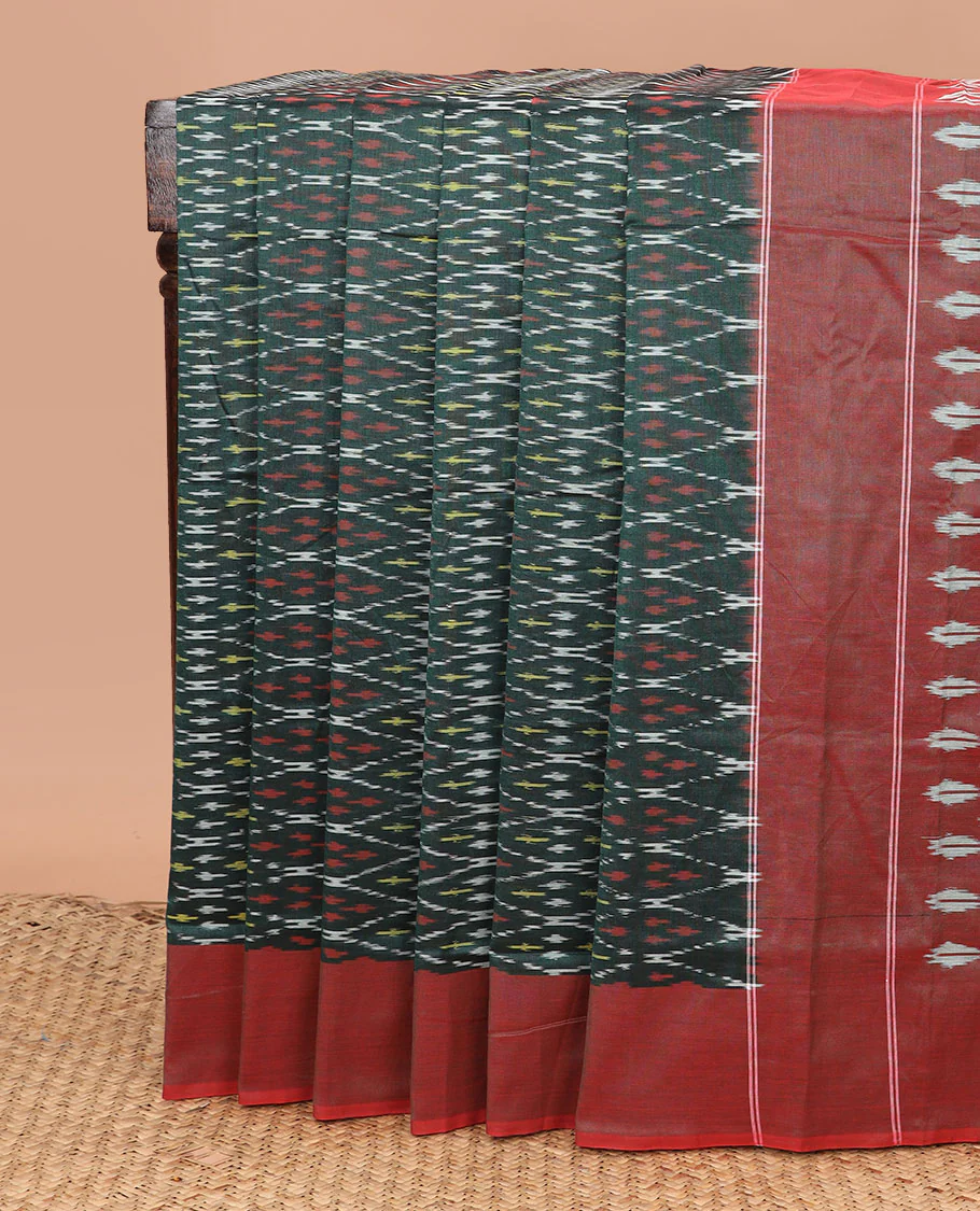 Green Ikkat Cotton Saree Decked Up with Geometric Patterns in Ikkat Weave, Complemented by a Contrast Plain Border, and Pallu Adorned with Ikkat Buttas