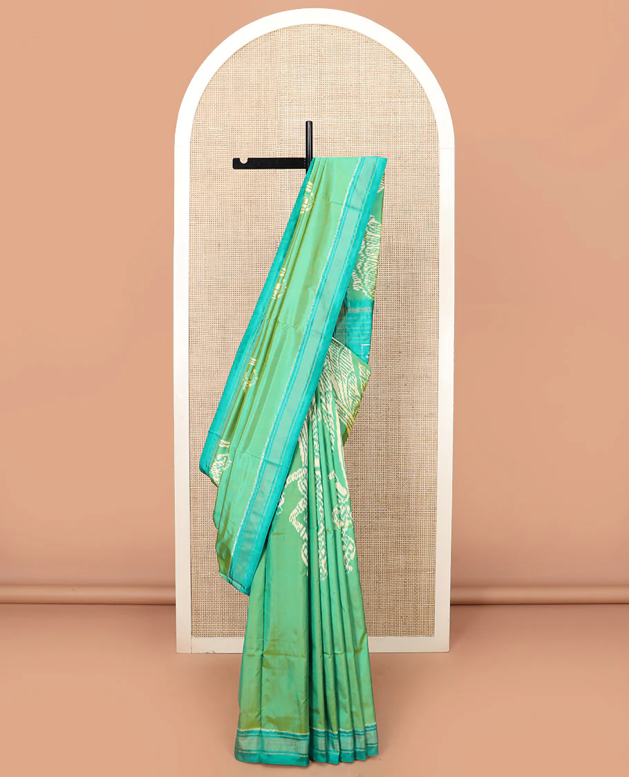 Green Ikkat Silk Saree Beautified with Human Figurines, Complemented by a Contrast Border, Hazily Woven Pallu of Geometric Patterns, and a Contrast Blouse - Image 2
