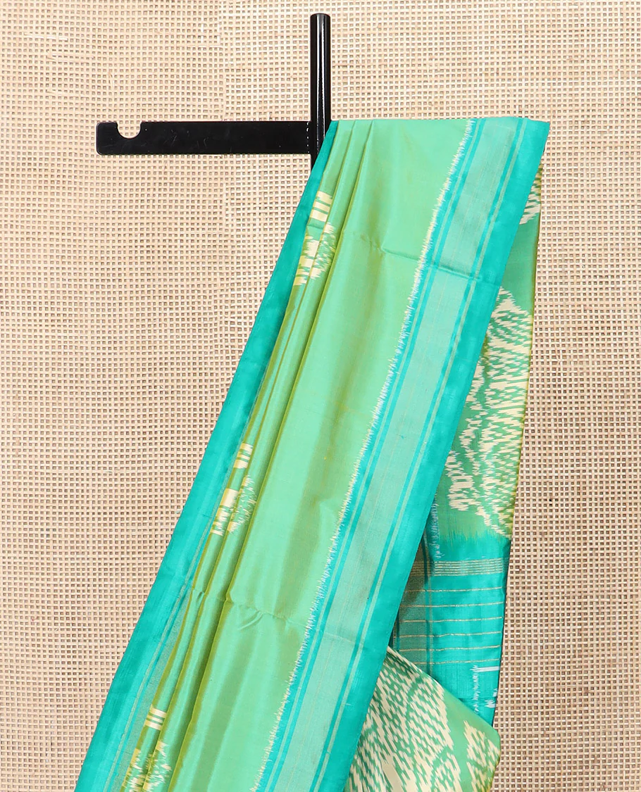 Green Ikkat Silk Saree Beautified with Human Figurines, Complemented by a Contrast Border, Hazily Woven Pallu of Geometric Patterns, and a Contrast Blouse - Image 3