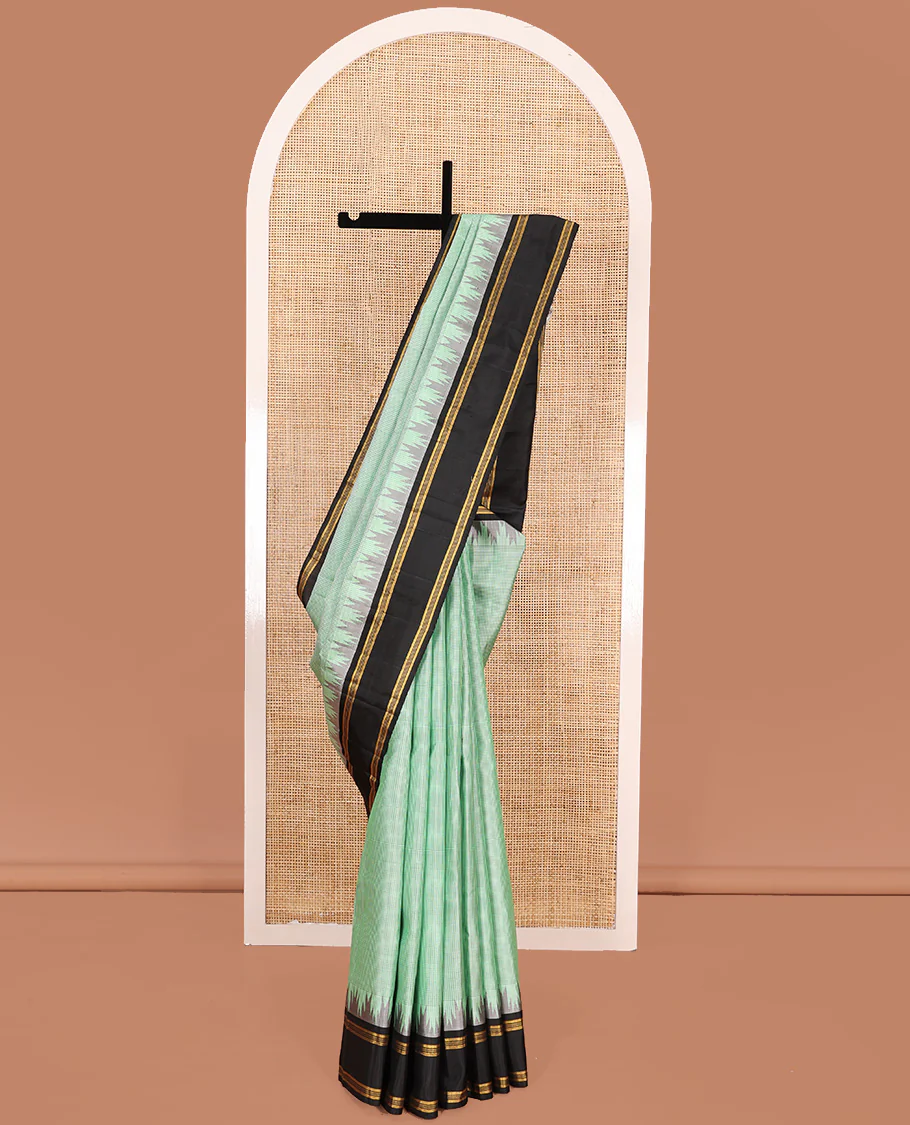 Green micro-checked Kanchipuram silk saree, contrast thazampoo rekku border, and zari striped pallu